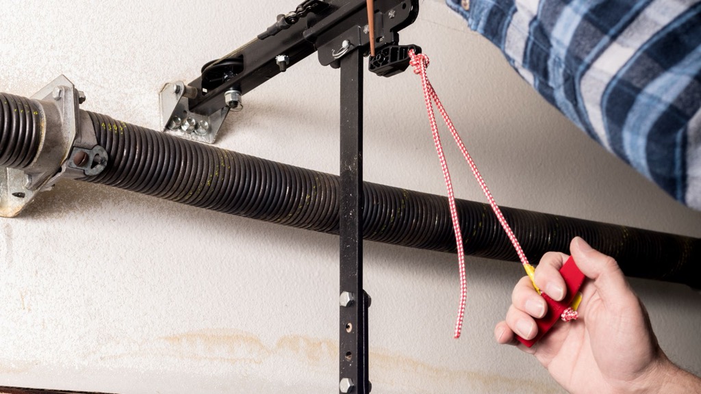 Broken garage door torsion spring being replaced on a cold morning in Cleveland, OH